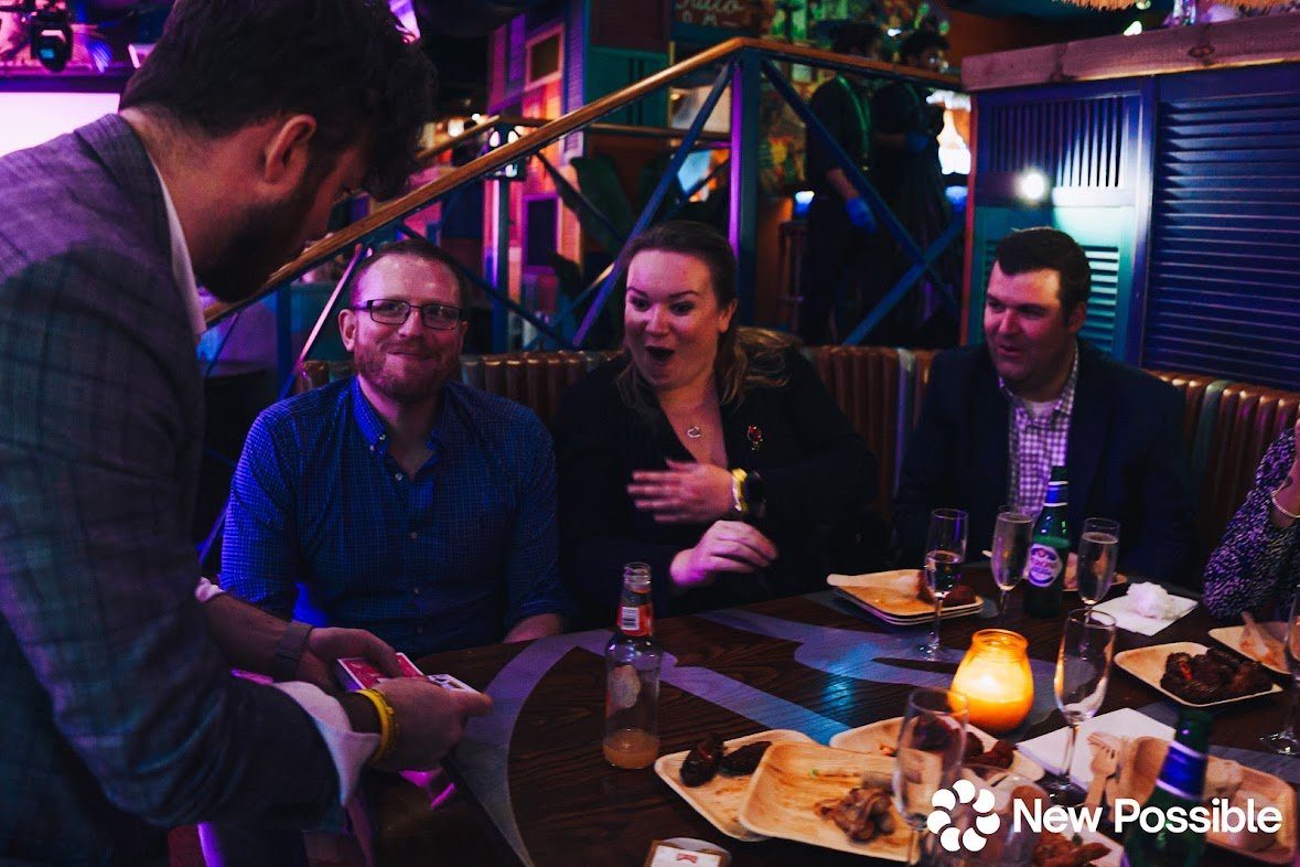 Event guests reacting to a magic trick by Interactive Magic