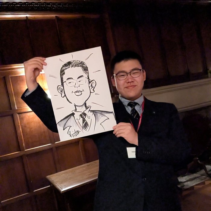 Guest holding his live caricature