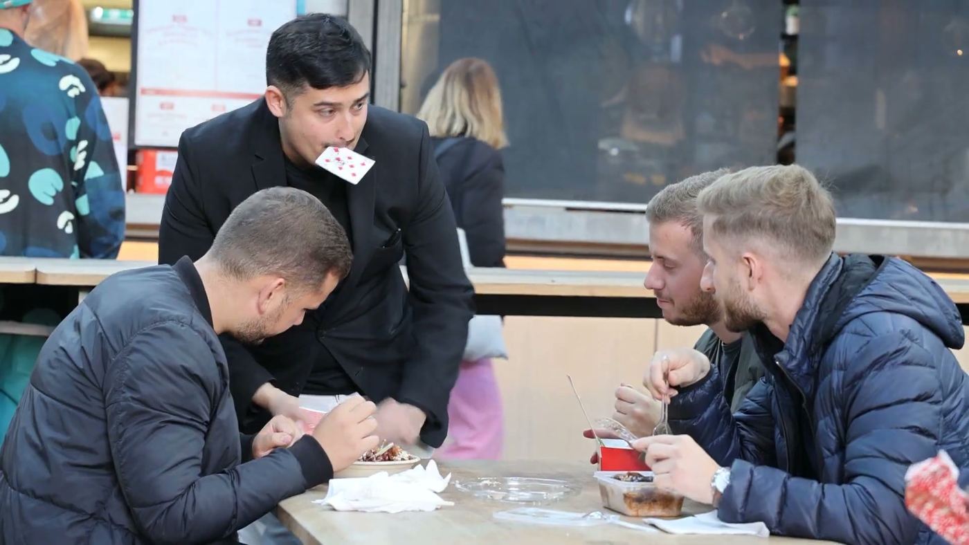 Guests watching a card being revealed at their table