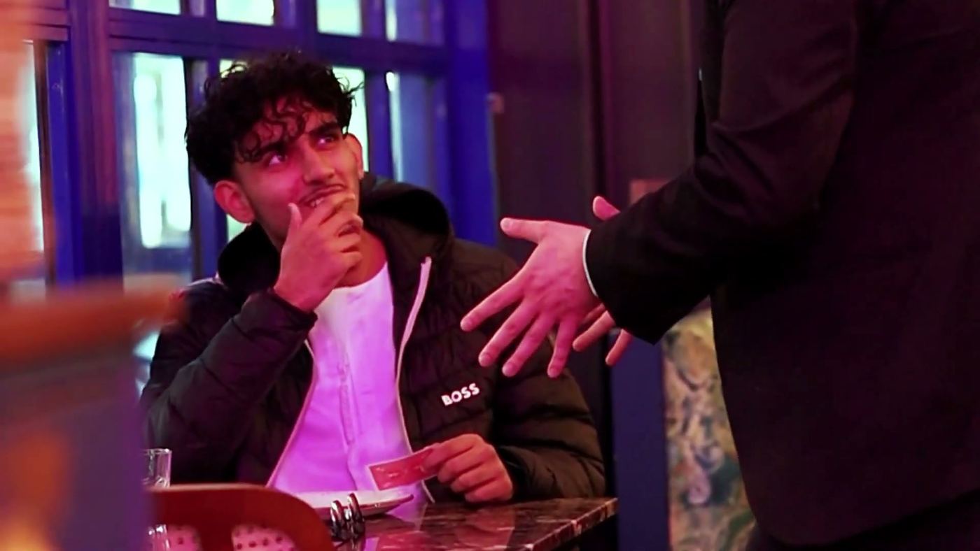 A guest reacting with disbelief to close-up magic