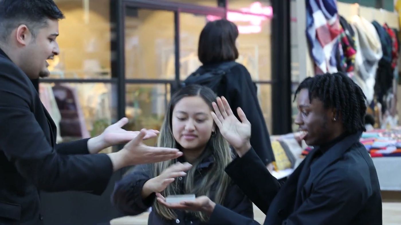 Guests throwing their hands up as a trick is revealed