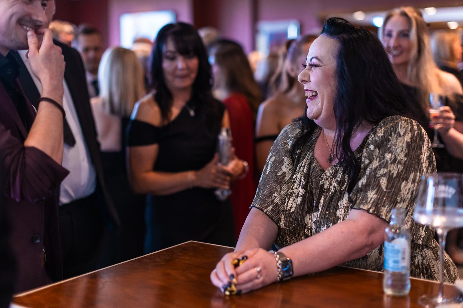 Close-up magic performed for seated guests in a relaxed bar setting