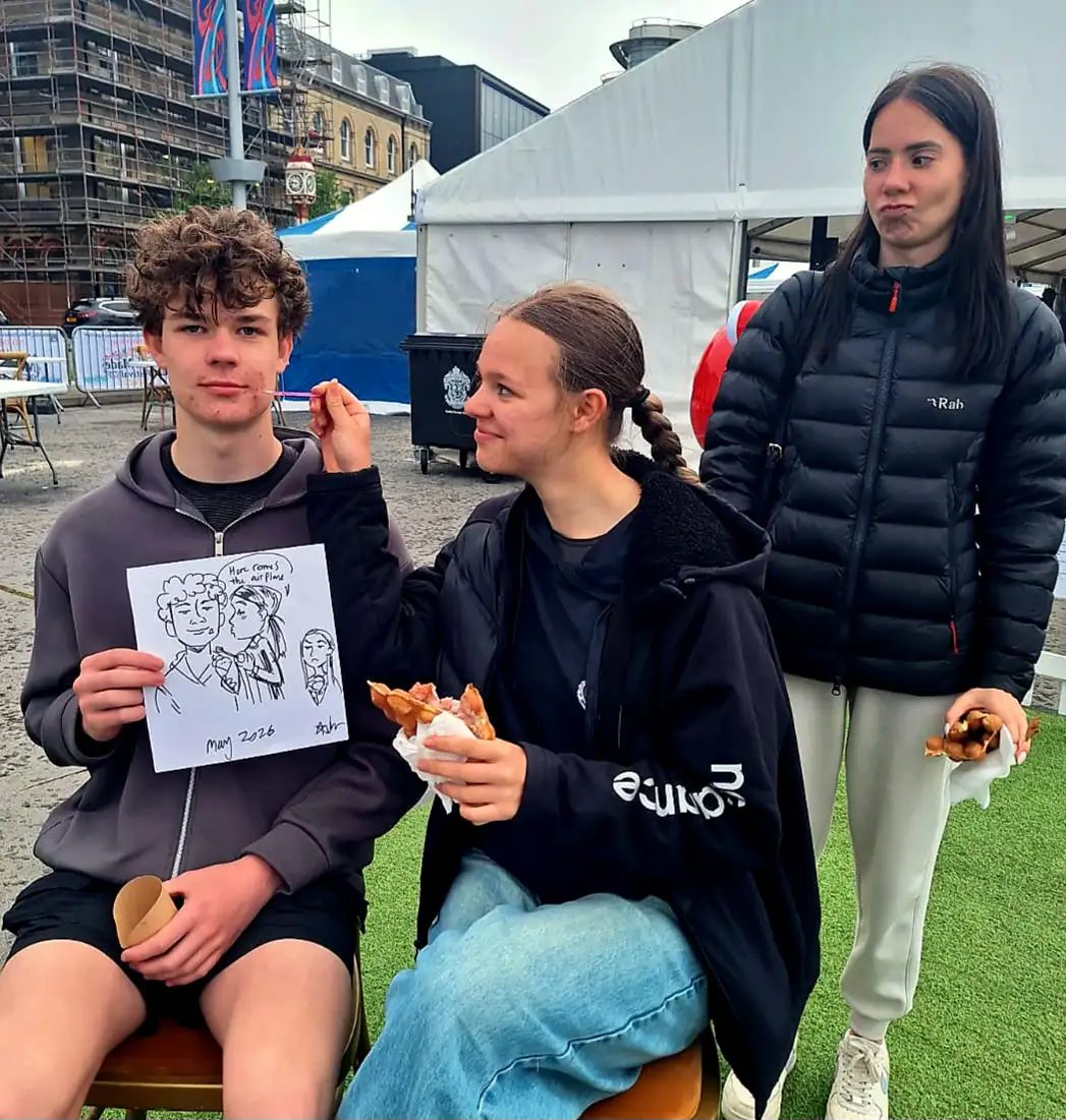 A guest holding a freshly drawn cartoon portrait at an event