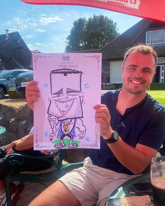 Guest at a golf club event holding his live caricature