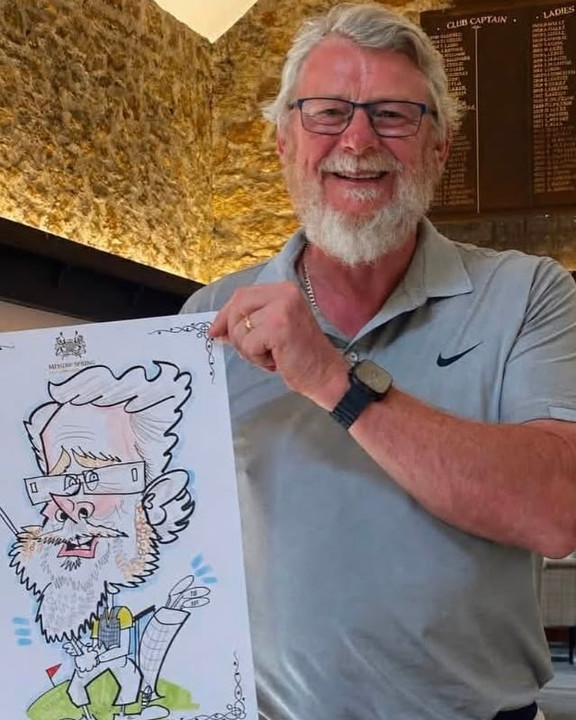 Golfer holding his live caricature at the clubhouse