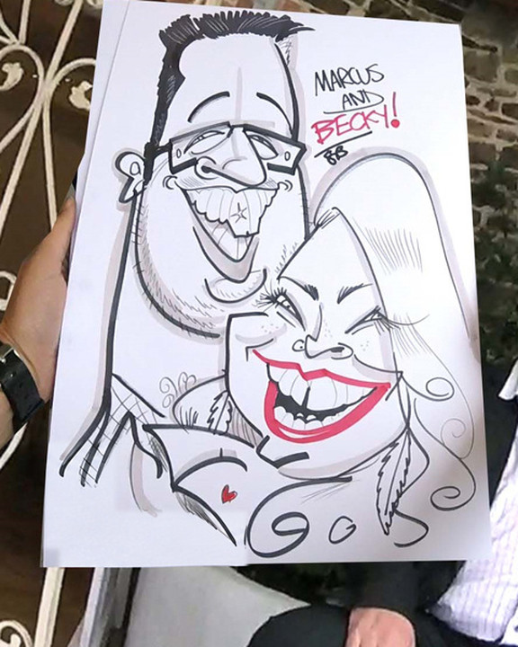 Couple laughing beside their live wedding caricature