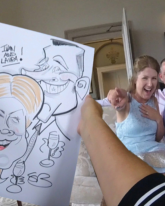 Bride and groom reacting to their live caricature