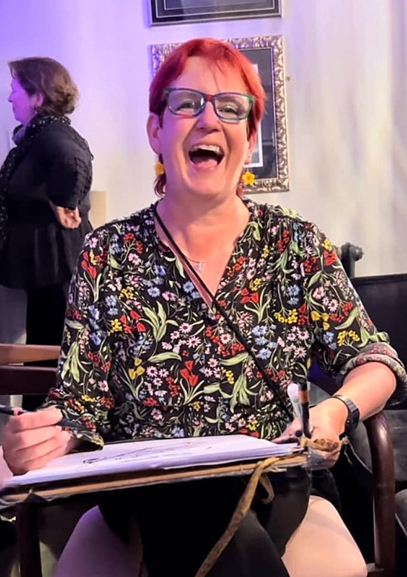 Cheeky Caricatures artist laughing while drawing a live caricature