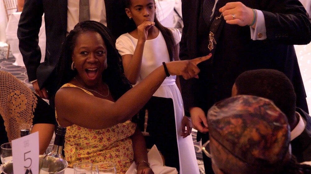 Chris performing a close-up magic routine for a small group of guests