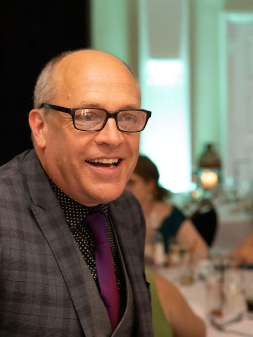 Jack, a Cornwall close-up magician, smiling at a wedding reception