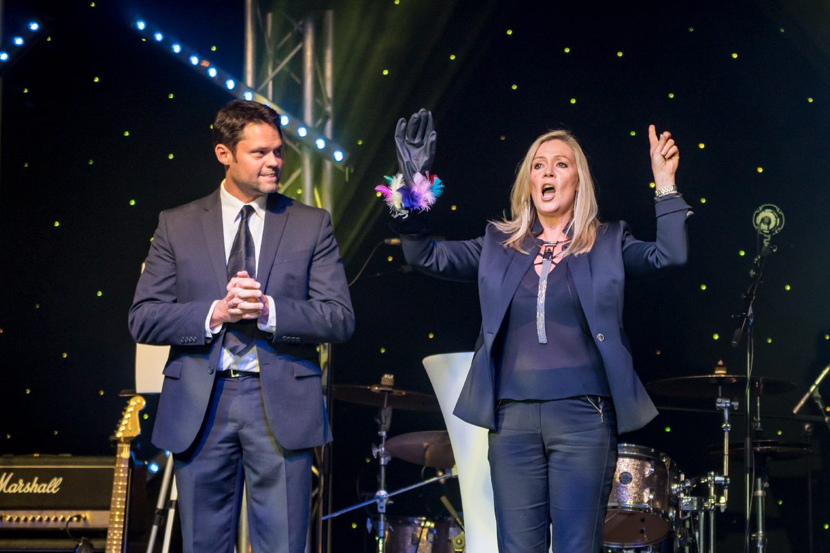 Aurora Myst on stage with a guest at an awards night
