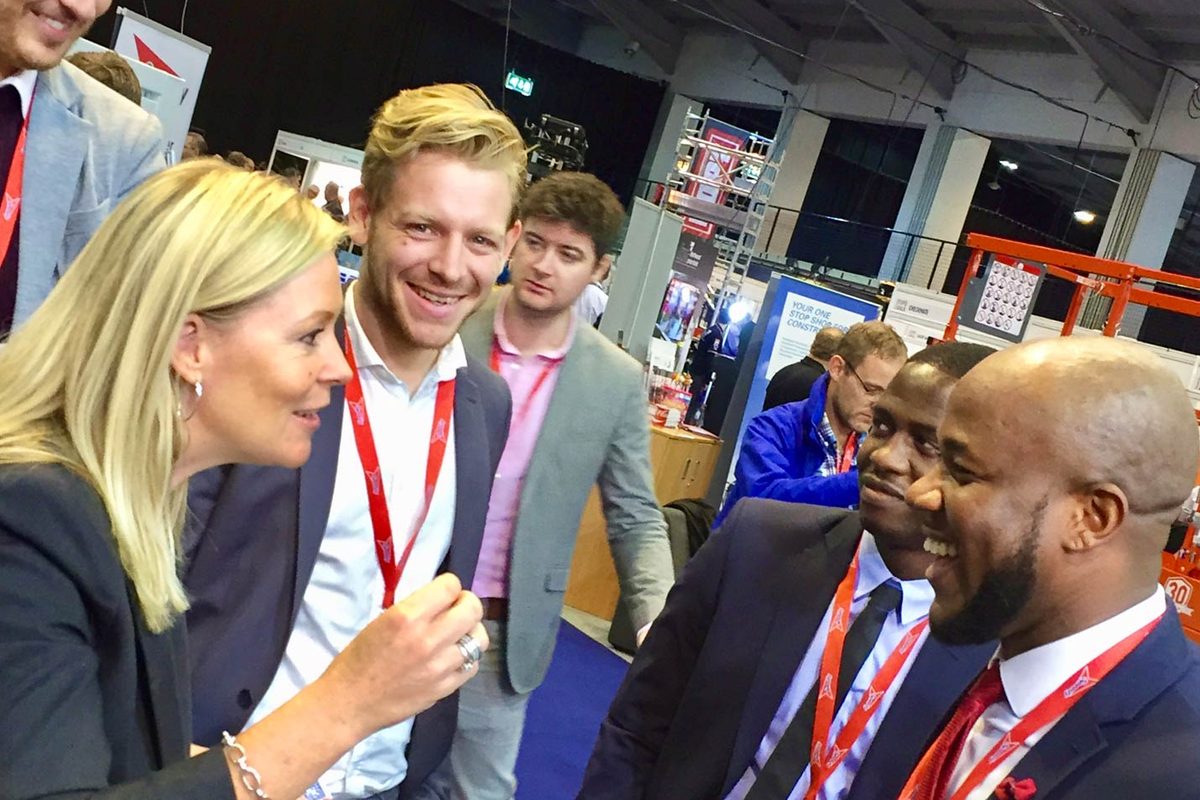 Aurora Myst performing magic for visitors at a trade show stand