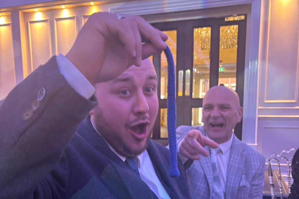 A guest holding up a rope in amazement after a magic trick by Banter Magic