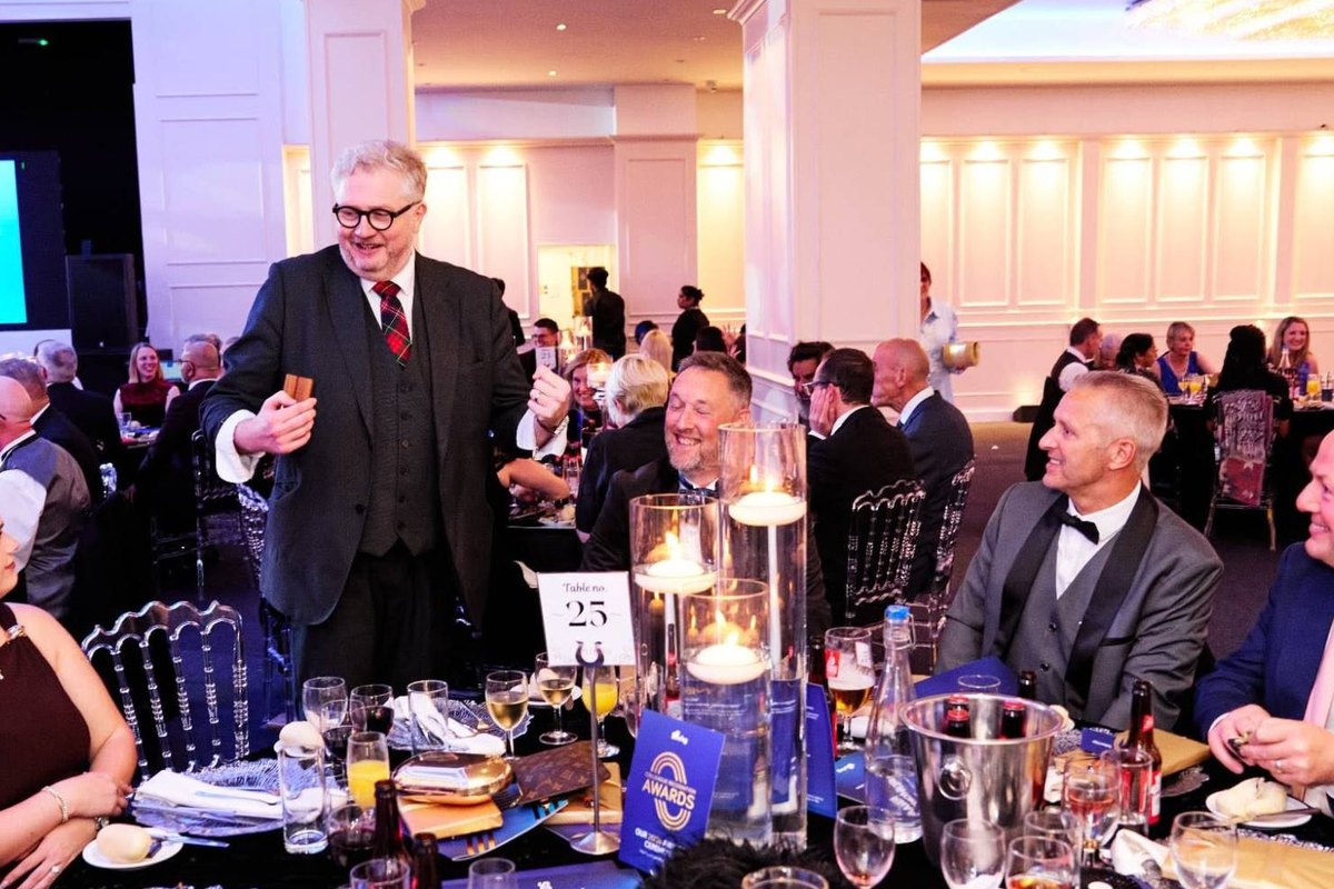 Banter Magic performing close-up magic for a full table at a corporate awards evening