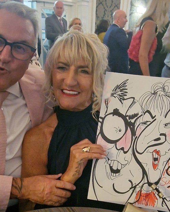 Wedding couple laughing with their colour caricature