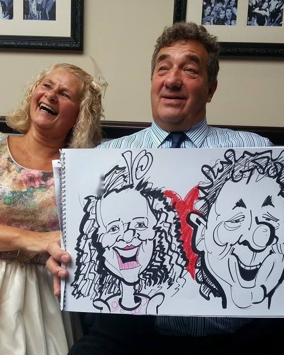 Couple at a hotel wedding with their caricature