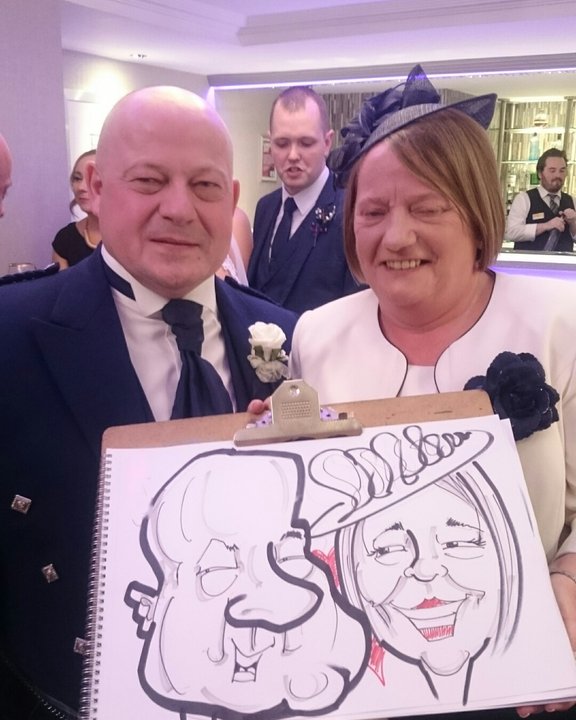 Guest in a kilt and his wife with their wedding caricature