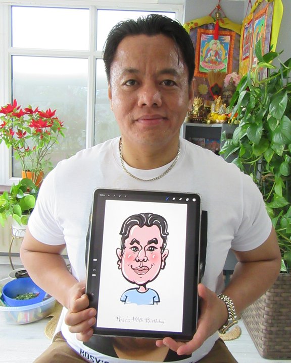 Guest holding an iPad showing his colour digital caricature at a birthday party