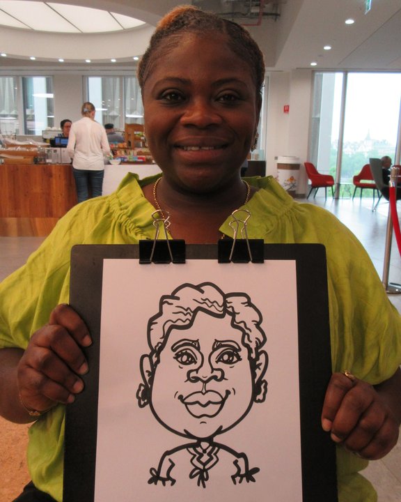 Smiling guest holding her live marker caricature at a corporate event