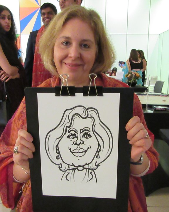 Guest holding her black and white caricature at a party