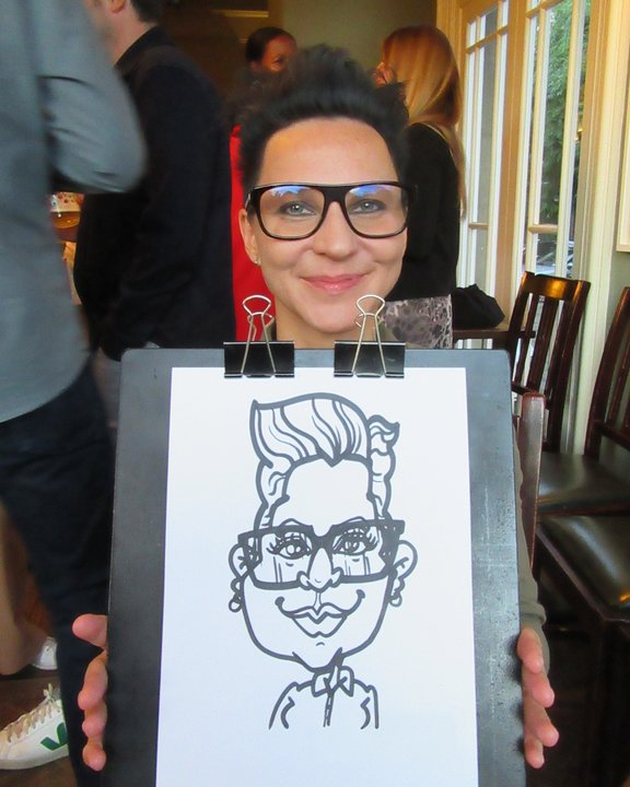 Guest in glasses holding her marker caricature at a party