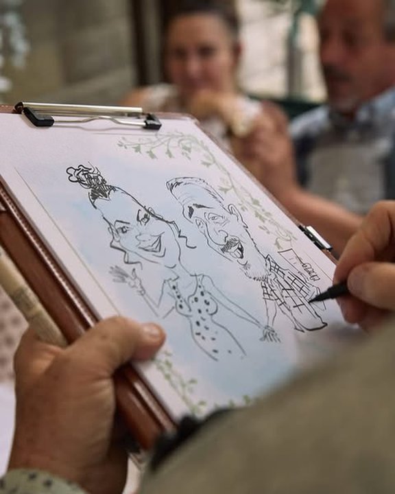 Couple caricature being drawn on a clipboard at a wedding