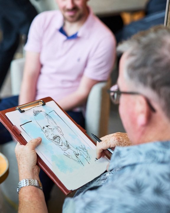 Caricature of a guest being sketched live at an event