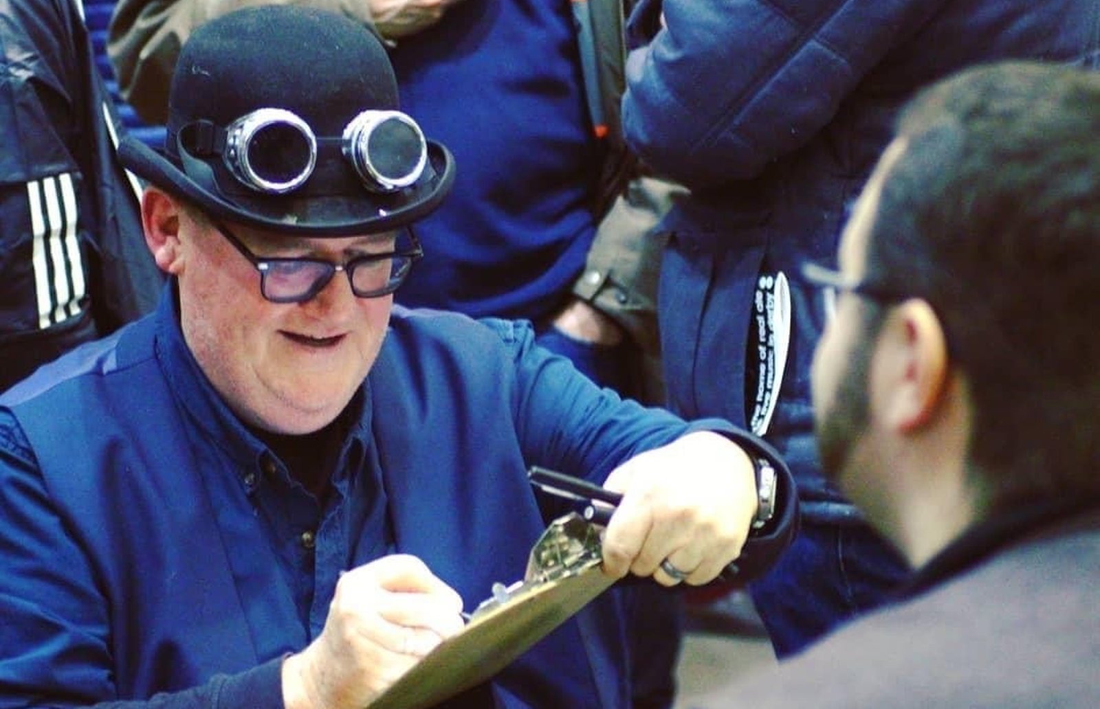 Cheerful Caricatures drawing a guest live on a clipboard at a busy event