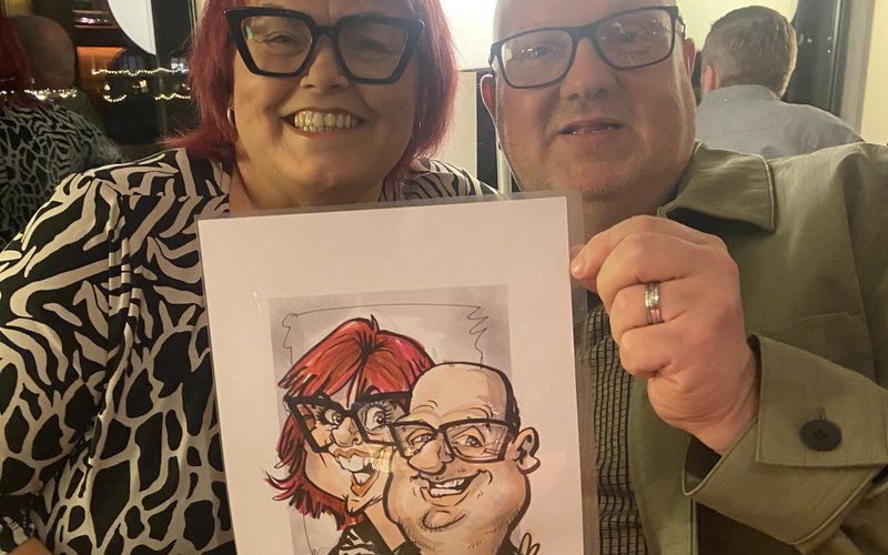 Colourful Caricatures - couple holding their colour live caricature
