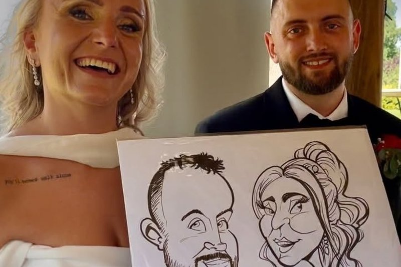 Bride and groom laughing with their live wedding caricature