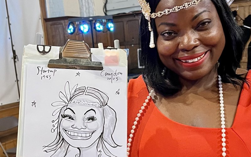 Dapper Caricatures - guest in a red dress with her live caricature