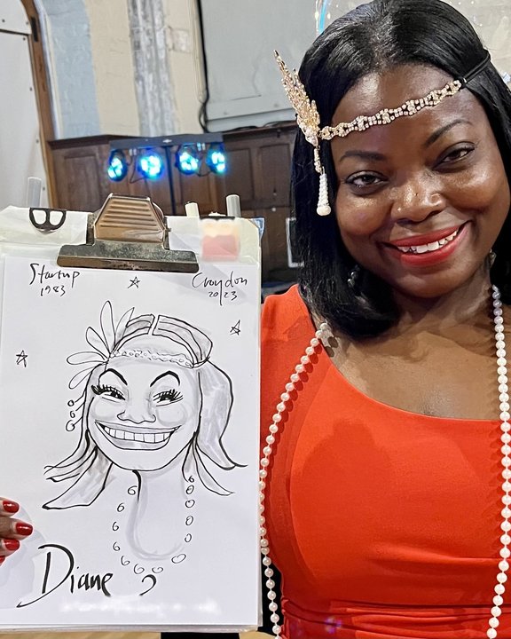 Guest in a red dress smiling with her live caricature