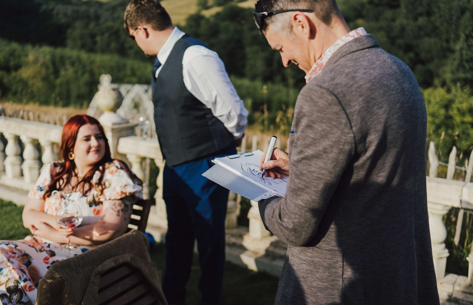 Dragon Caricatures drawing a guest live on a terrace at a country wedding