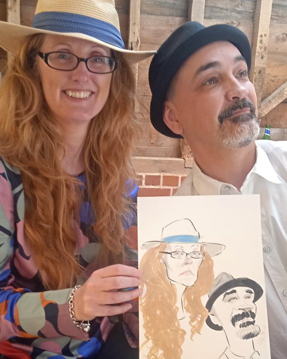 Wedding guests holding their couple caricature