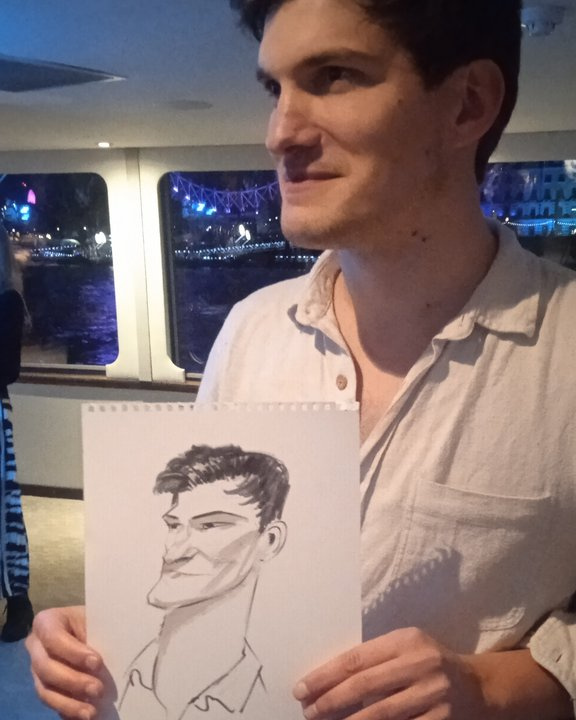 Wedding guest holding his live caricature