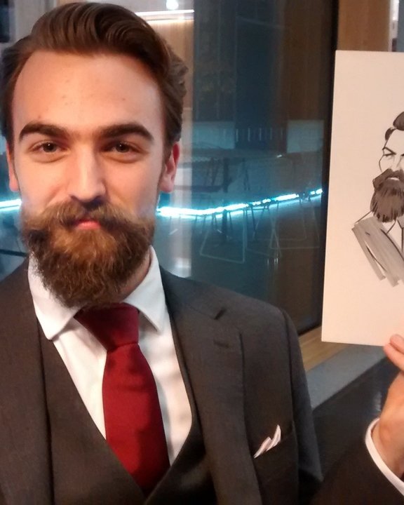 Guest with a beard holding his caricature at a Christmas party