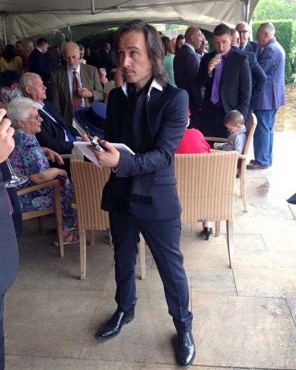 Caricaturist drawing guests at a garden party
