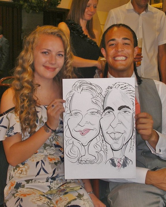 Wedding guests holding their couple caricature