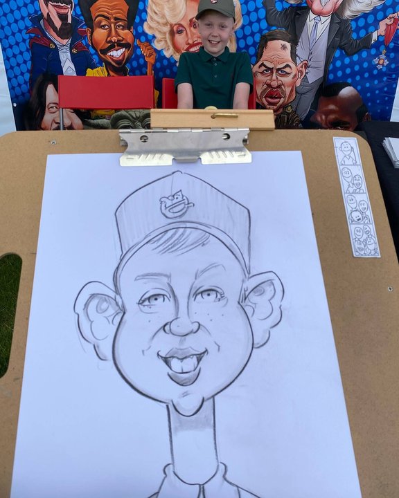Child's caricature drawn live on the easel at a fun day