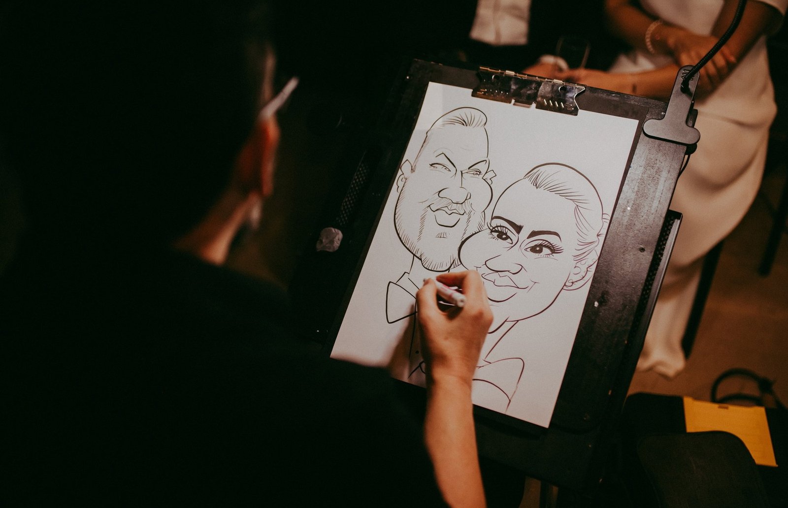 Saltire Caricatures drawing a wedding couple live at an easel