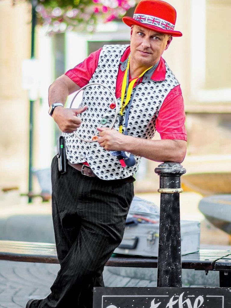 Showtime Magic, a comedy magician from Warwickshire, in a red bowler hat and patterned waistcoat