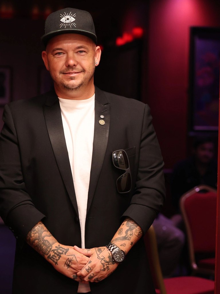 Streetwise Magic, a Brighton close-up magician, in a black blazer and cap