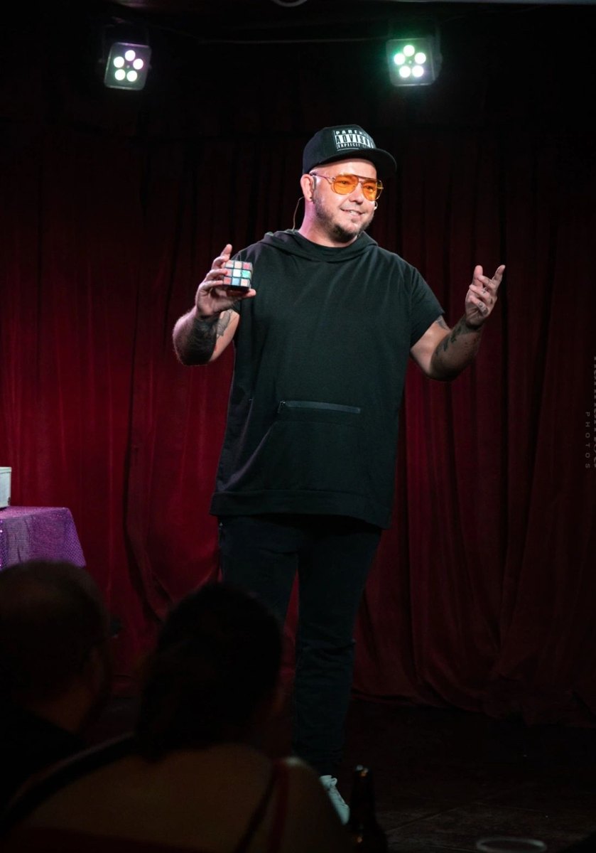 The magician on stage during his stand-up show