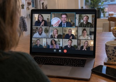 Laptop on a kitchen table showing a virtual magic show on a team video call