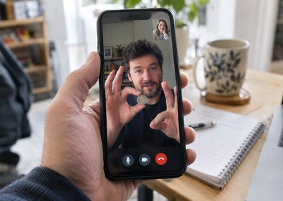 Virtual magician performing coin magic on a phone video call